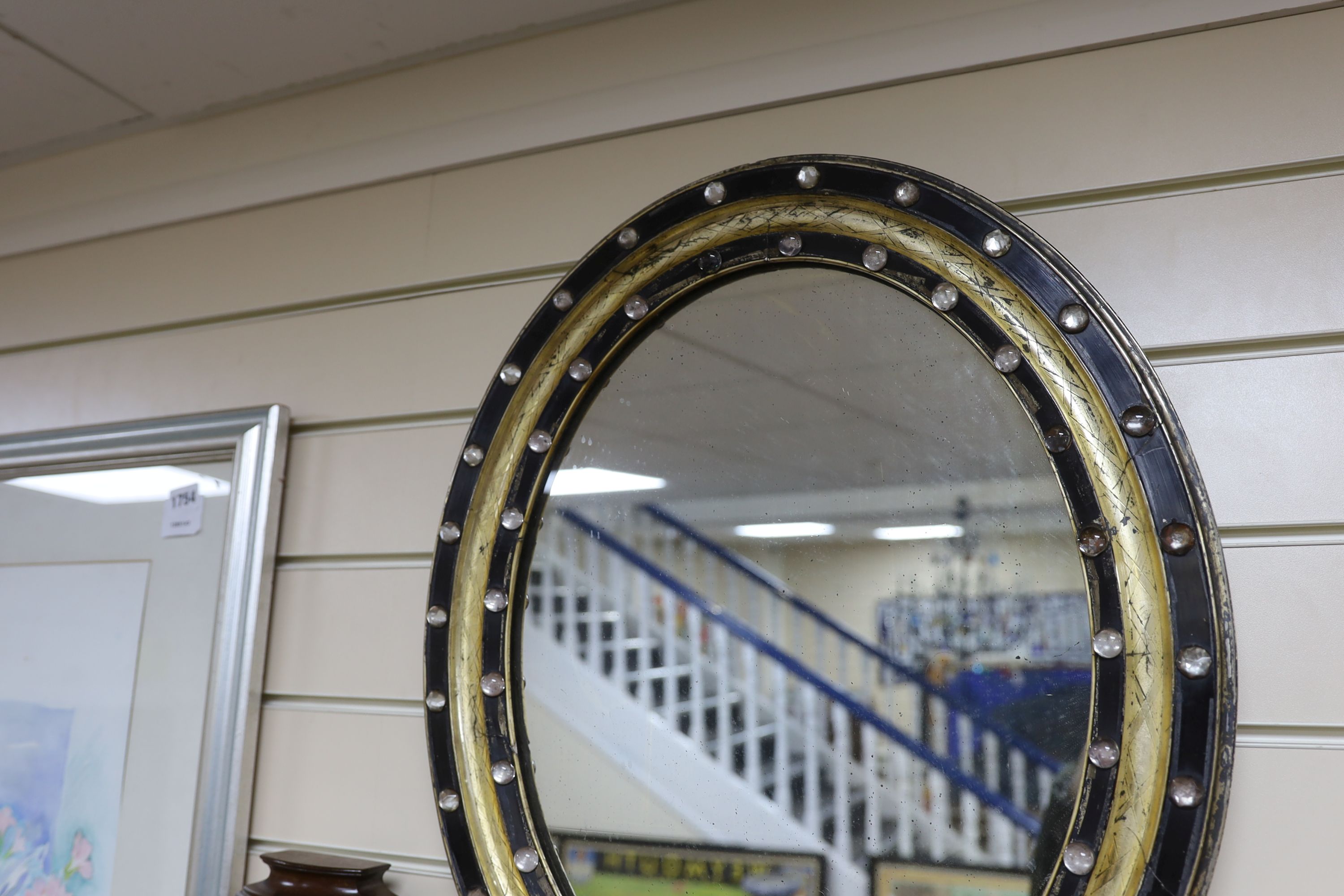 A small 19th century Irish oval wall mirror, with twin faceted and cabochon glass border, width 46cm, height 56cm